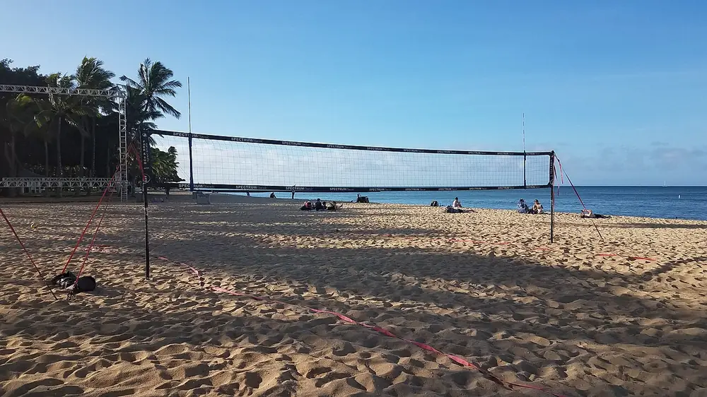 alas pilipinas odds - A volleyball net on a palm-lined beach court