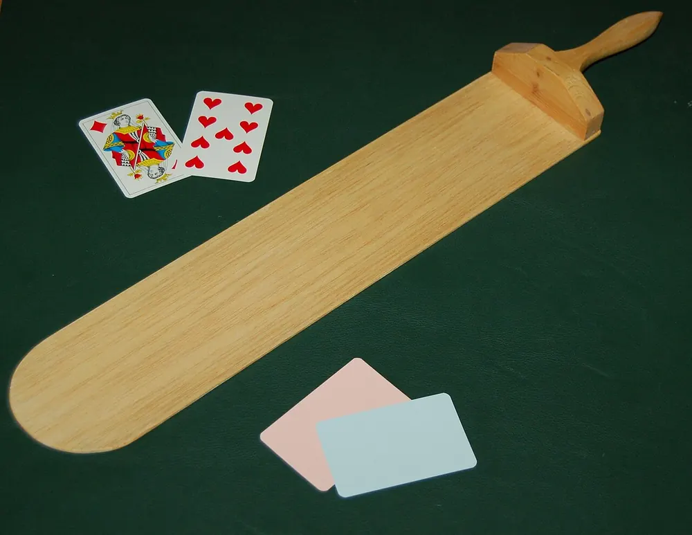 baccarat tips for beginners - Baccarat paddle and playing cards on green felt