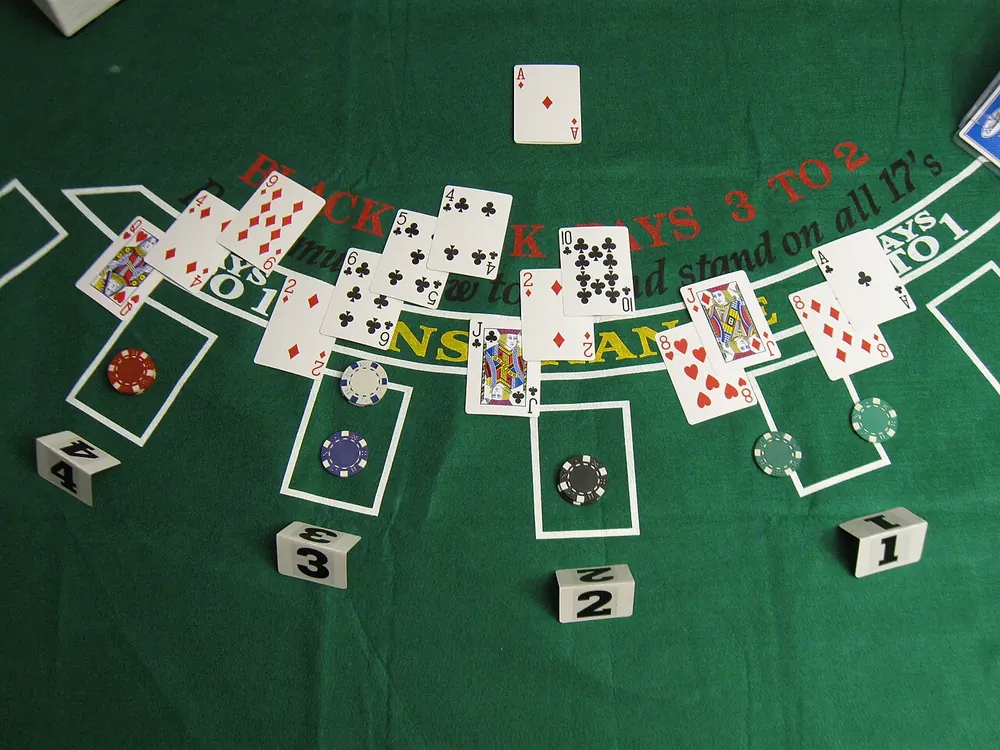 blackjack rules tagalog - Blackjack table felt with dealt hands and chips