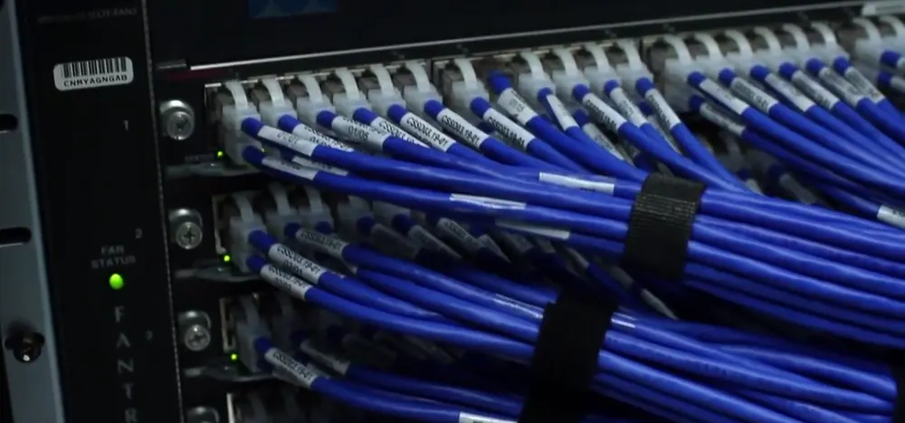 Network cables in a server rack, illustrating blockchain networks and fees - cheapest way to send crypto philippines