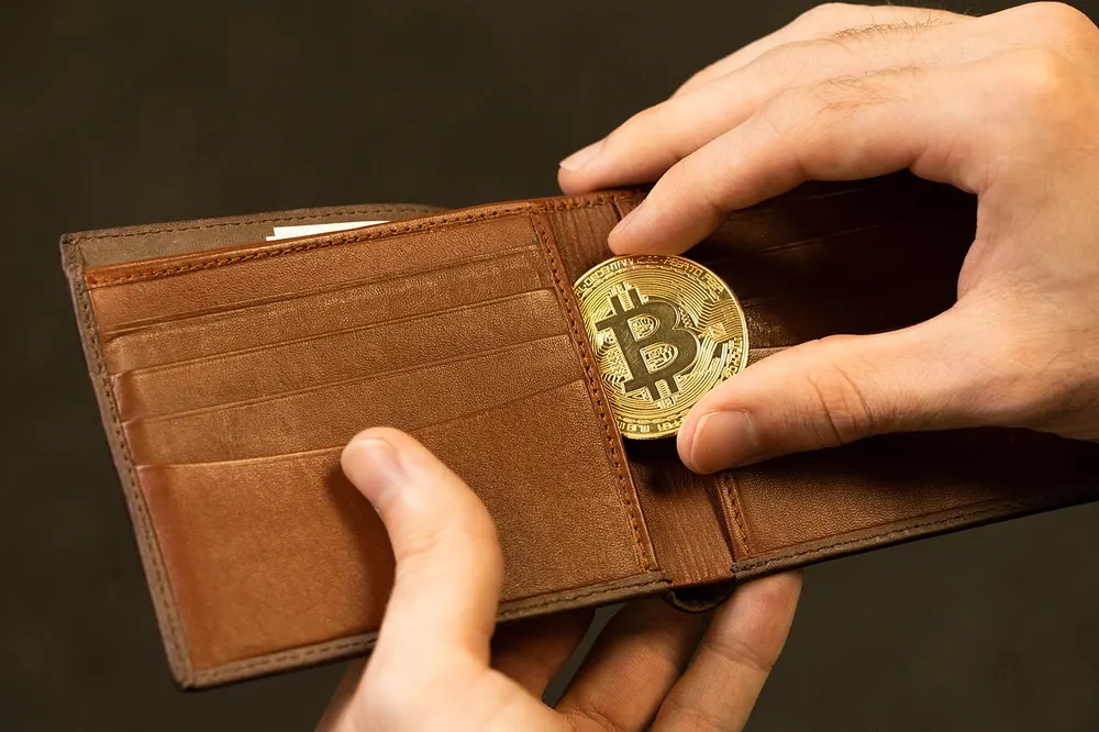 cloudbet minimum withdrawal - Bitcoin coin in a leather wallet, illustrating Cloudbet minimum withdrawal amounts