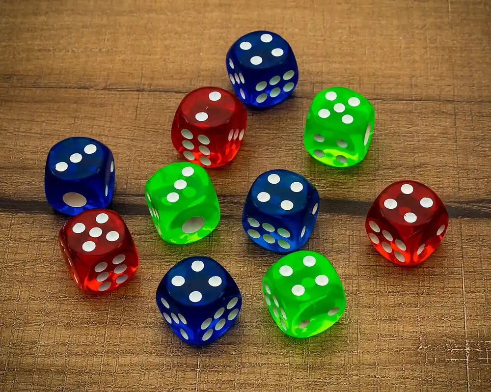 Colourful dice scattered on a table - color game perya tips and tricks