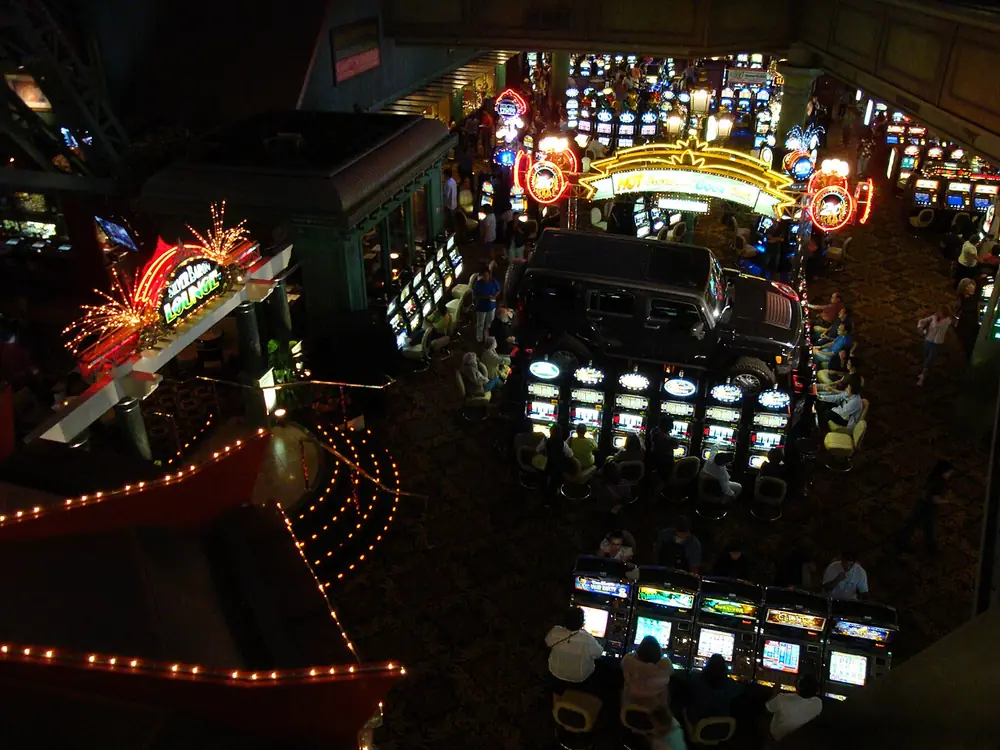 Slot machines glowing in a dark gaming hall - crypto casino free spins philippines