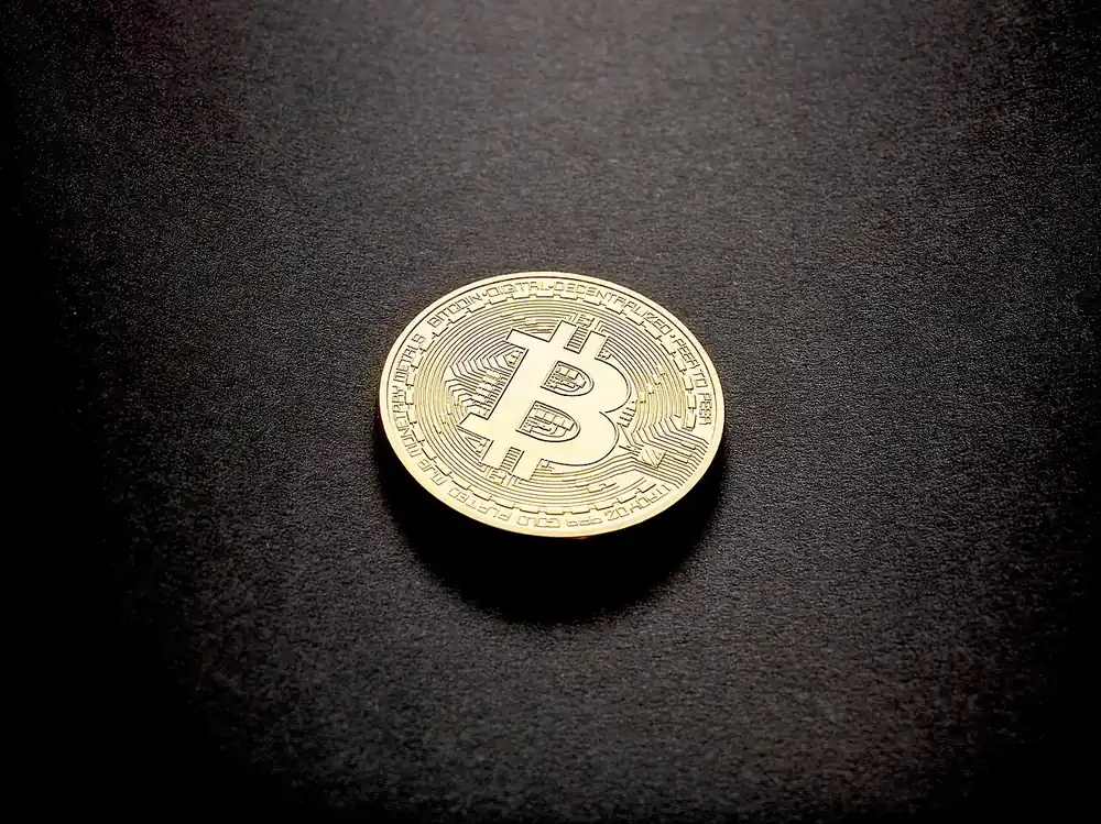 Single crypto coin on a dark background, illustrating crypto transfers from gcrypto - esports betting gcash