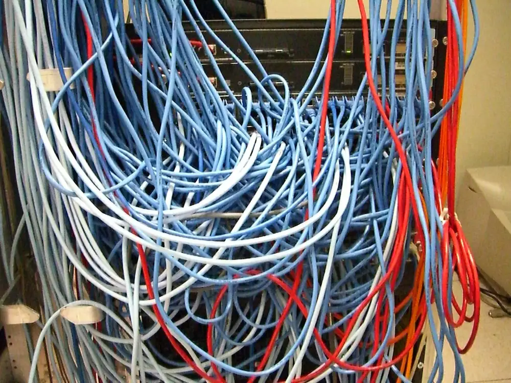 gcash usdt network - Server rack with tangled network cables, illustrating choosing a USDT network in GCash