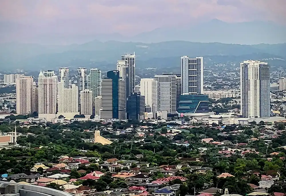 Ortigas center skyline above green neighbourhoods - how to buy usdt in okx using gcash