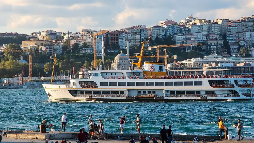 Ferry on the bosphorus with istanbul's hillside neighbourhoods behind - m series mlbb world championship odds