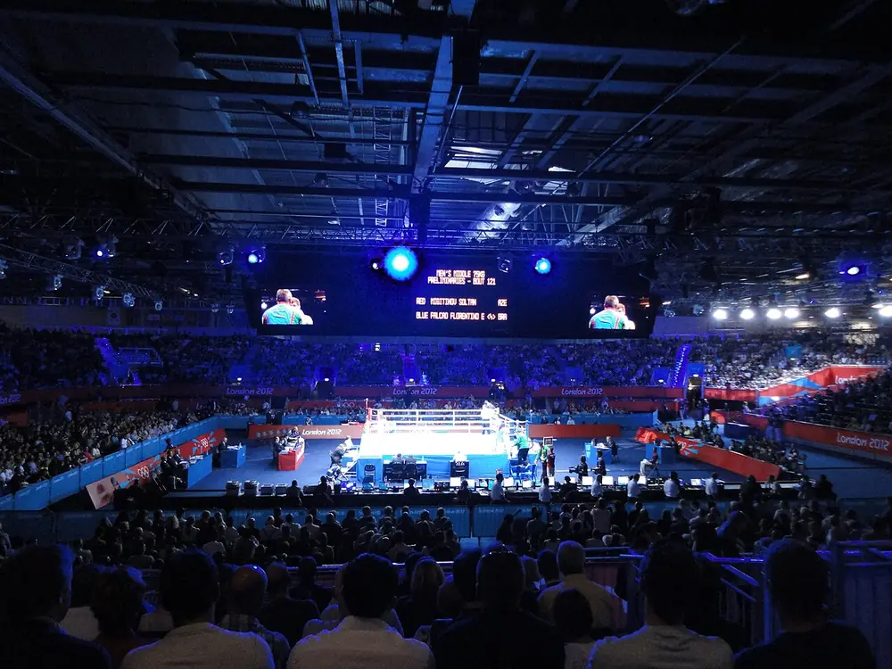 manny pacquiao betting odds - Boxing ring lit under blue arena lights before a big fight night