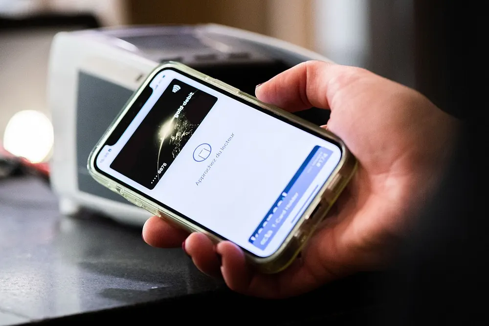 Smartphone held at a contactless terminal, illustrating mobile payments in the philippines - maya to usdt