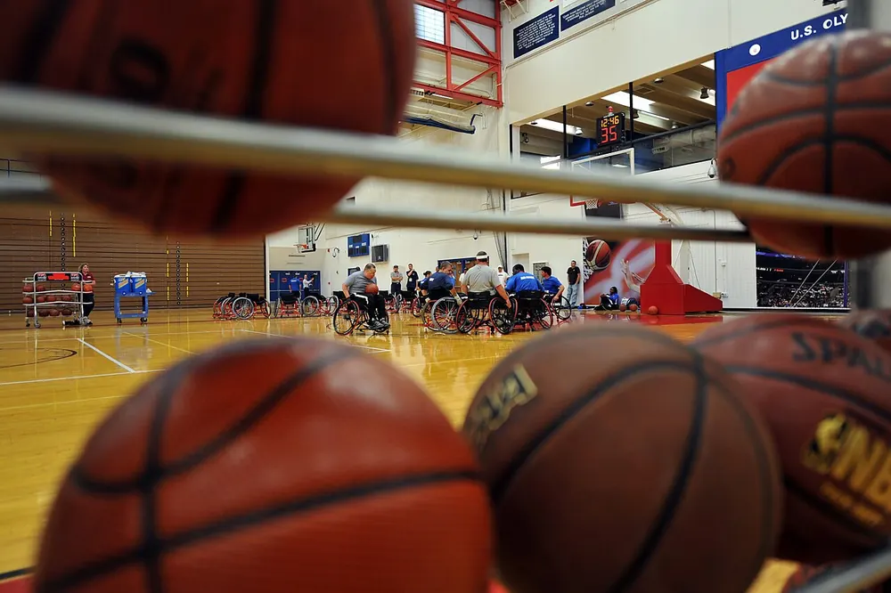 A rack of basketballs beside a court - nba player props philippines