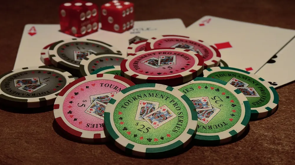 online poker philippines real money - Poker chips, playing cards and dice on a table, representing real-money online poker