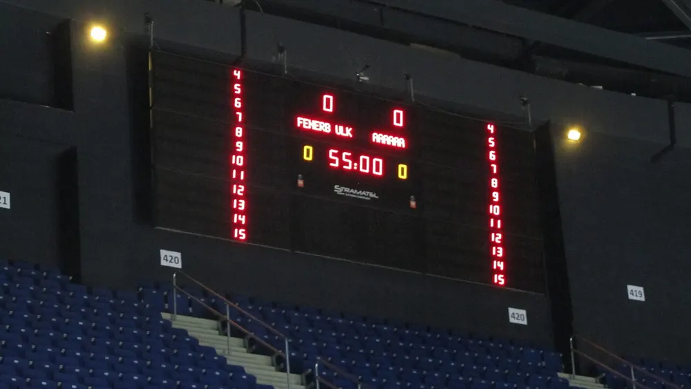 pba betting odds pinnacle - Empty basketball arena with a lit scoreboard before tip-off