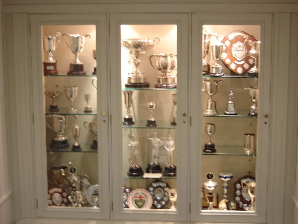 pba championship odds - Glass cabinet full of silver trophies, illustrating PBA championship futures odds
