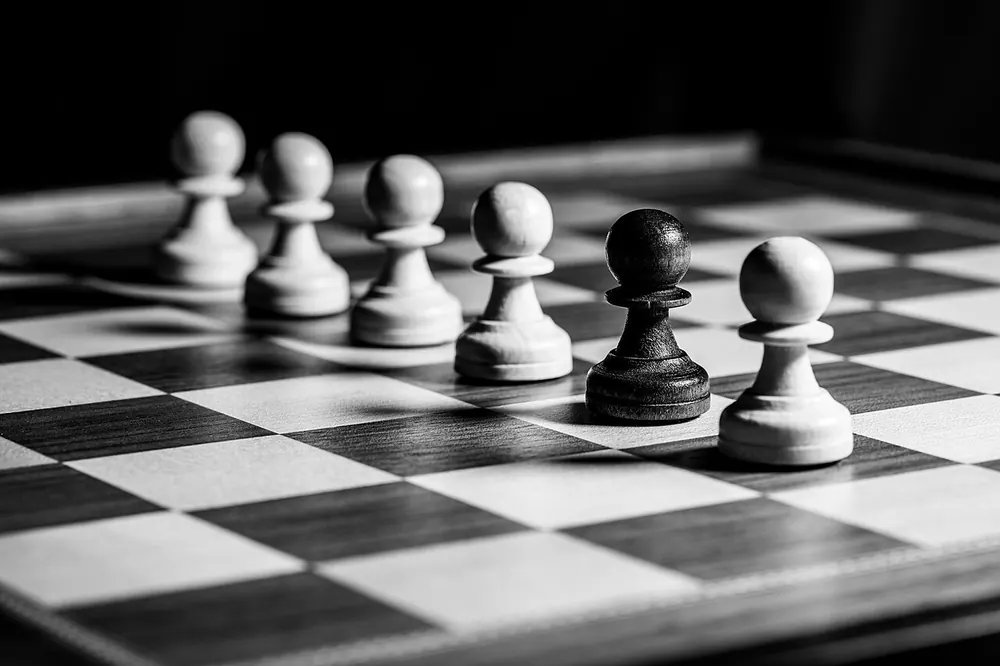 Black and white chess pieces on a board, representing a step-by-step method for game-day predictions - pba finals odds today predictions