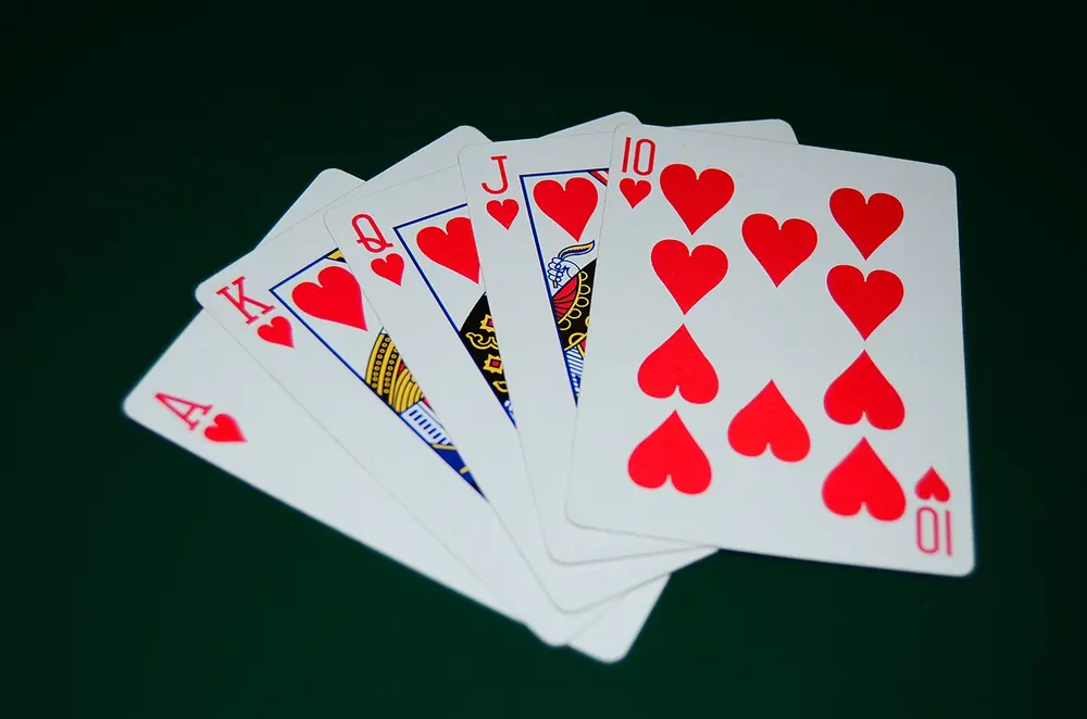 video poker real money philippines - Royal flush in hearts fanned on a dark table