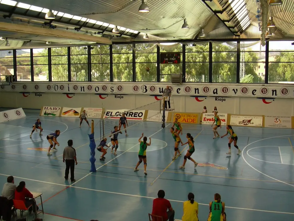 pvl all filipino conference odds - Indoor volleyball hall with players warming up on court