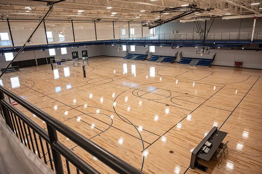 pvl betting - an empty indoor sports hall with a volleyball net set up