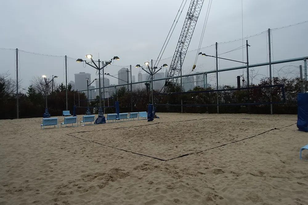 An empty sand volleyball court and net - pvl betting