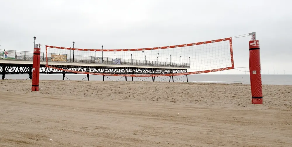 pvl odds - a volleyball net on an empty beach court