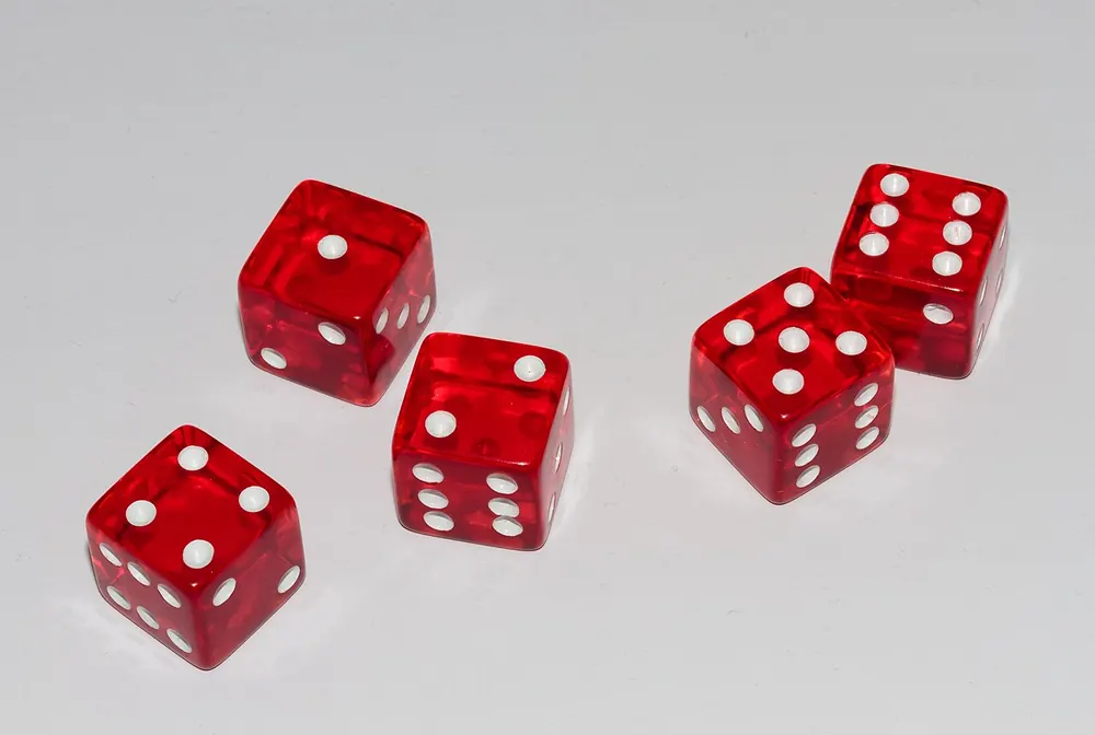 sic bo payout table - Red dice on a light background, representing sic bo outcomes