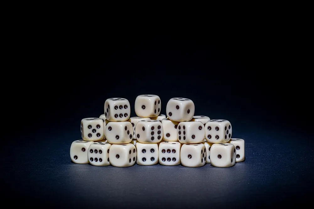 Pile of white dice, illustrating the 216 possible sic bo results - sic bo payout table