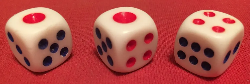 sic bo rules - Three white dice on a red table