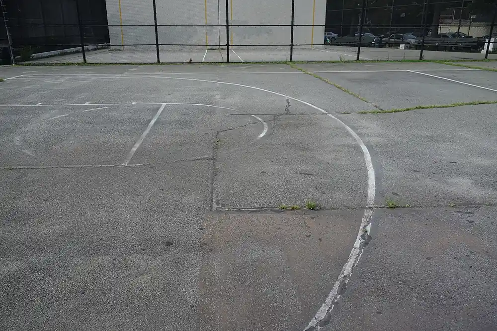 An empty outdoor asphalt basketball court - tayaan sa basketball