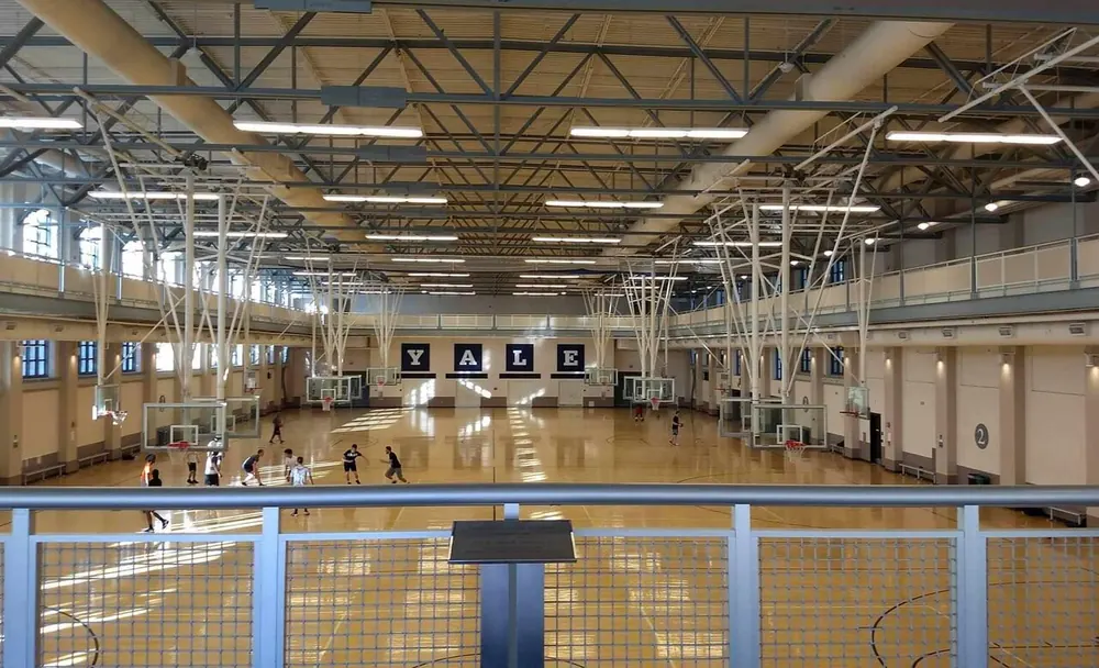 uaap betting odds - Empty university gymnasium with multiple basketball courts