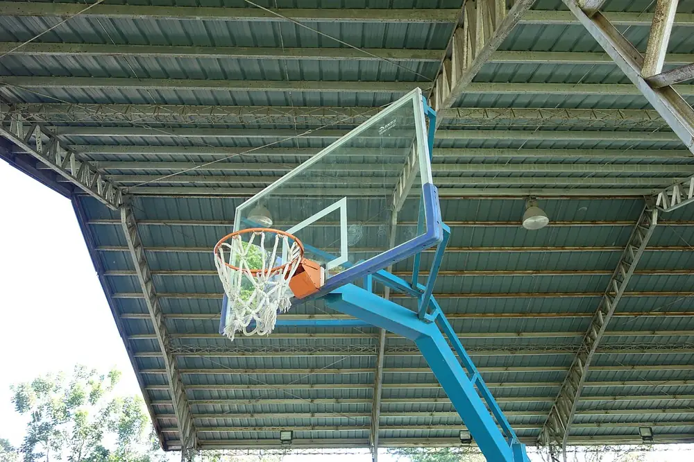 A basketball hoop inside an empty school gym - uaap volleyball betting site