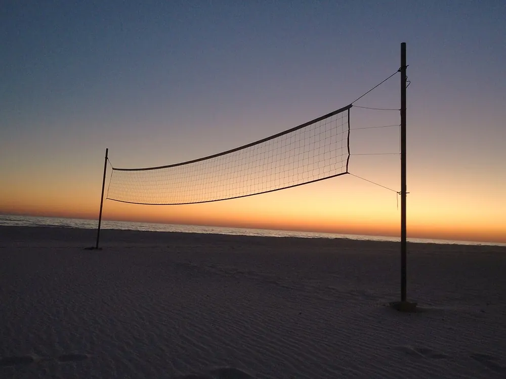 volleyball over under points betting - Beach volleyball net at sunset, volleyball over/under points betting