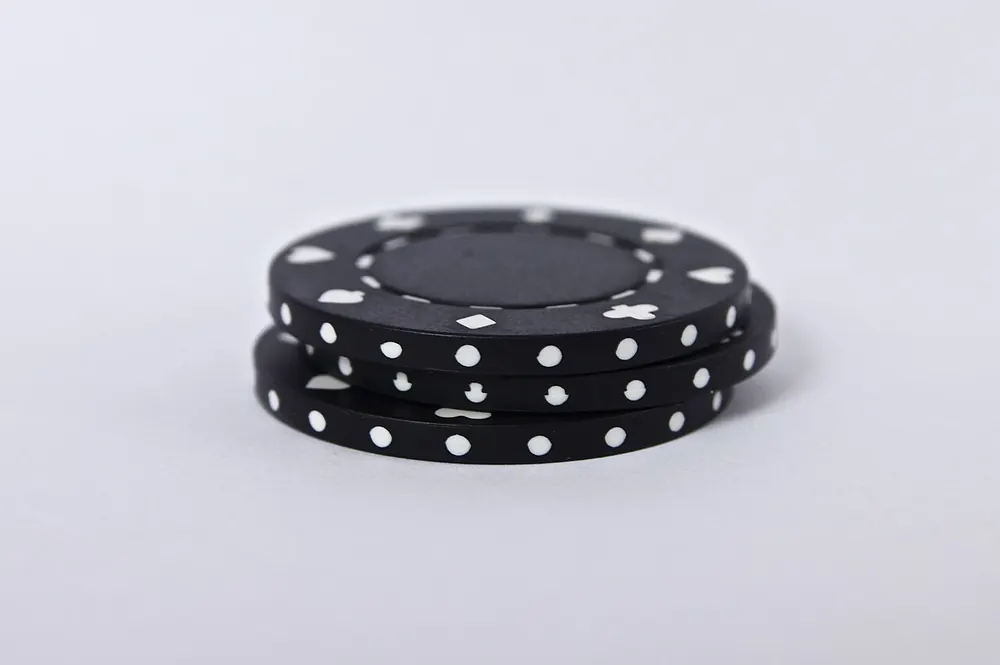 Small stack of plain black casino chips - wagering requirements explained philippines