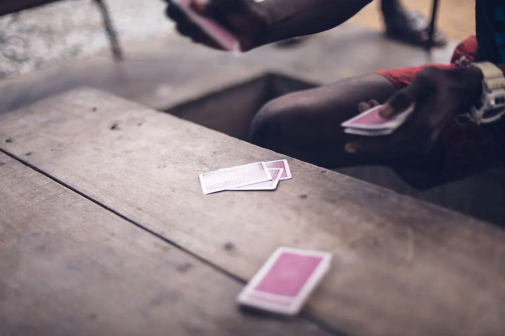 Playing cards dealt on a wooden table - what is lucky 9